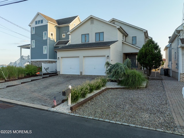 149 Valencia Dr, Brick, NJ 08723 - traditional-style house featuring an attached garage and decorative driveway