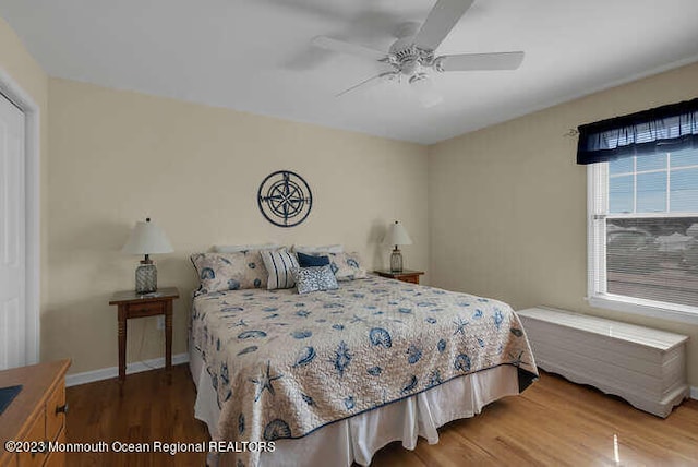 bedroom with ceiling fan and wood-type flooring