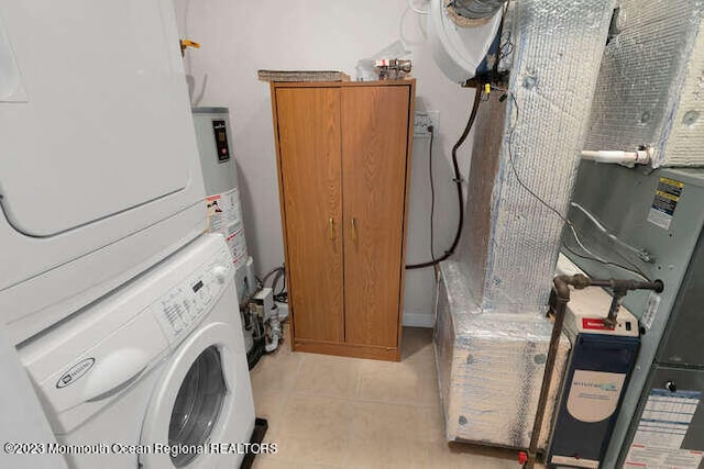 laundry room with light tile patterned floors and stacked washer and clothes dryer