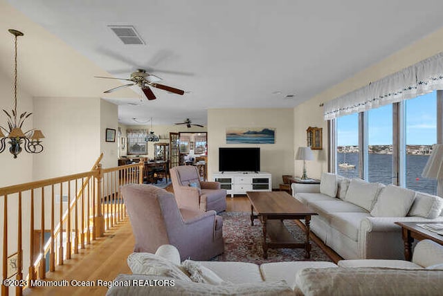 living room with ceiling fan and hardwood / wood-style floors