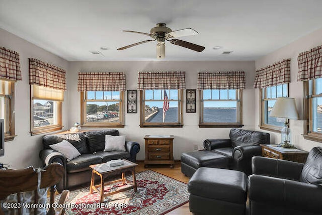 living room with ceiling fan and light wood-type flooring