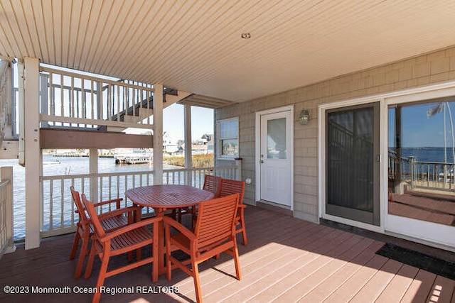 wooden deck featuring a water view