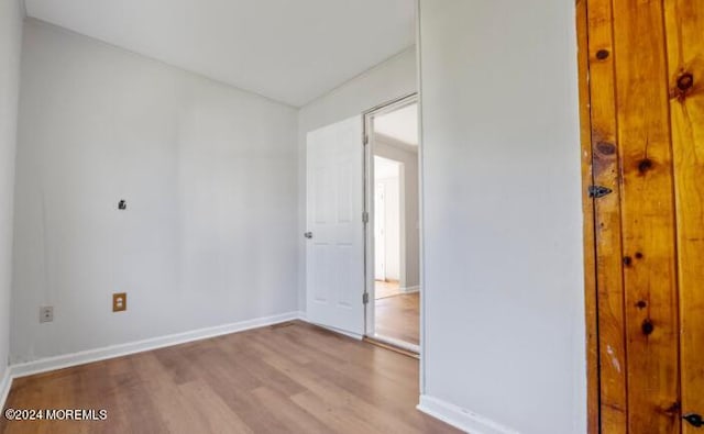 empty room with baseboards and wood finished floors