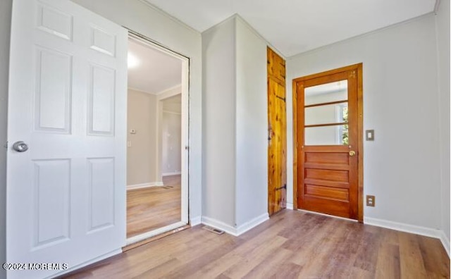 foyer entrance with baseboards and wood finished floors