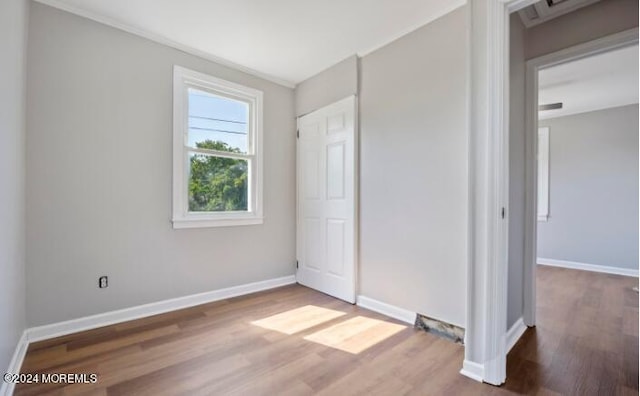 unfurnished bedroom featuring wood finished floors and baseboards