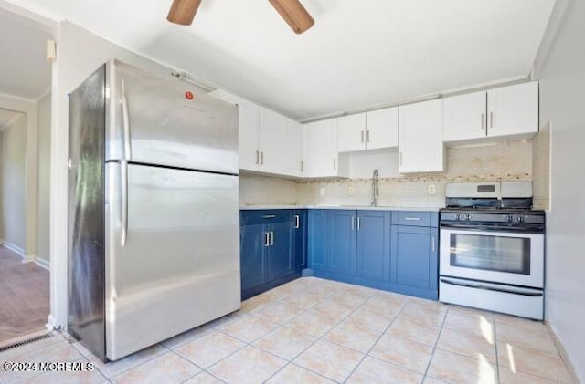 kitchen featuring ceiling fan, light countertops, stainless steel appliances, white cabinetry, and blue cabinets