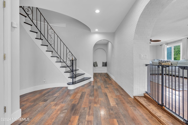 entrance foyer with ceiling fan and wood-type flooring