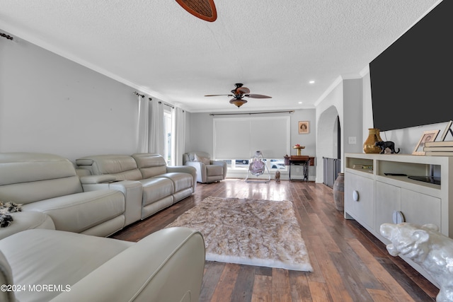 living room with crown molding, dark wood-type flooring, a textured ceiling, and ceiling fan