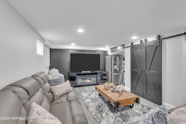 living room featuring hardwood / wood-style flooring and a barn door