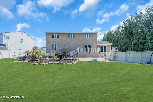 back of house featuring a yard and a patio area