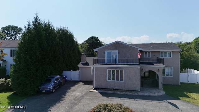 view of front of house featuring a balcony