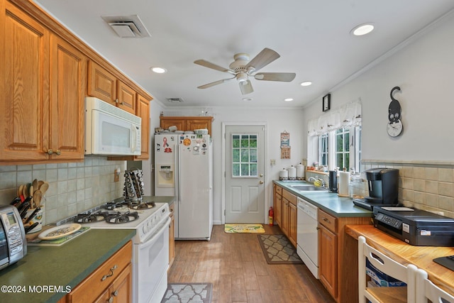 kitchen featuring ceiling fan, decorative backsplash, white appliances, crown molding, and light hardwood / wood-style flooring