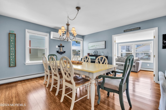 dining area featuring a wealth of natural light, light hardwood / wood-style floors, and baseboard heating