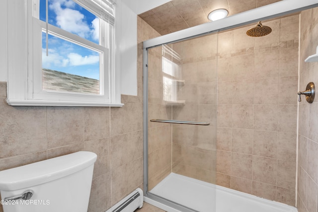 bathroom featuring tile walls, a shower with door, and toilet