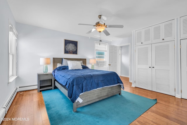 bedroom with ceiling fan, cooling unit, hardwood / wood-style floors, and a baseboard heating unit