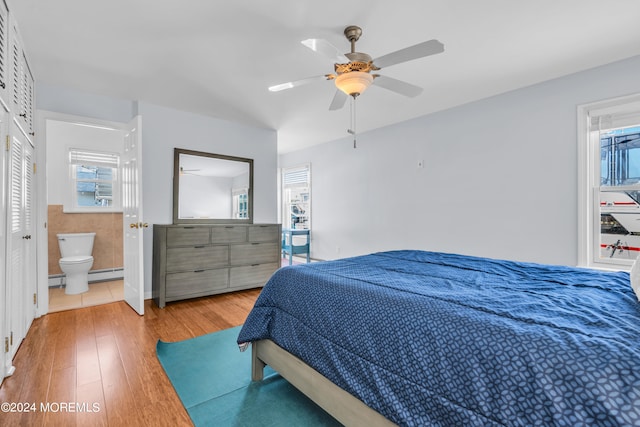 bedroom with connected bathroom, light hardwood / wood-style floors, and ceiling fan