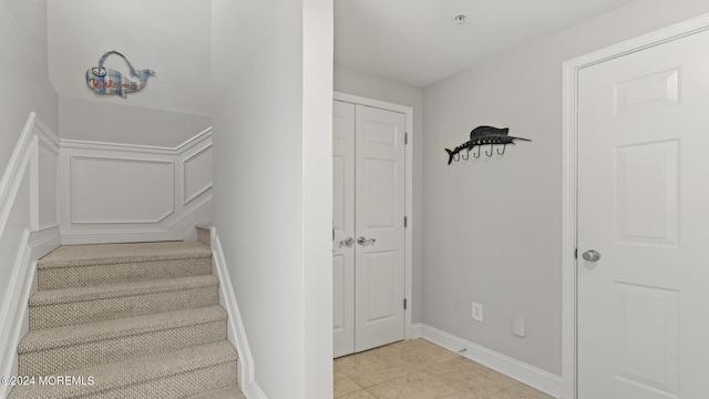 staircase with tile patterned floors