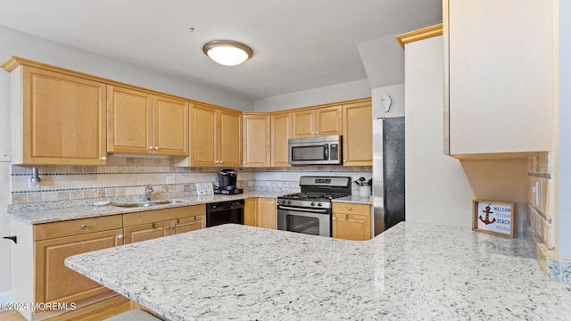 kitchen with sink, kitchen peninsula, stainless steel appliances, and decorative backsplash