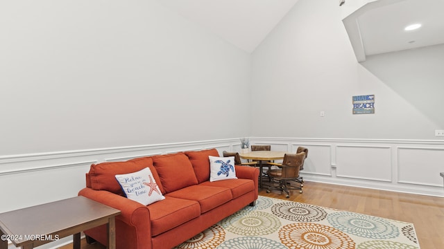 interior space with vaulted ceiling and light hardwood / wood-style flooring