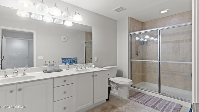 bathroom with vanity, toilet, an enclosed shower, and tile patterned floors