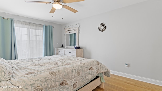 bedroom with light hardwood / wood-style flooring and ceiling fan