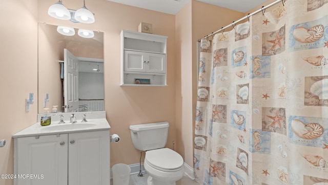 bathroom with vanity, toilet, curtained shower, and tile patterned flooring