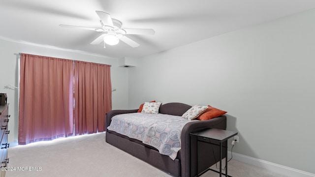 bedroom featuring ceiling fan and light carpet