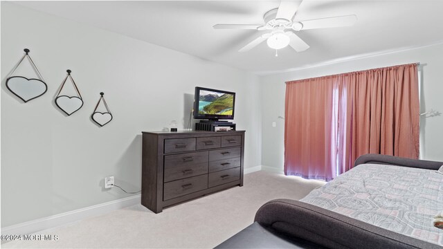 bedroom with light carpet and ceiling fan