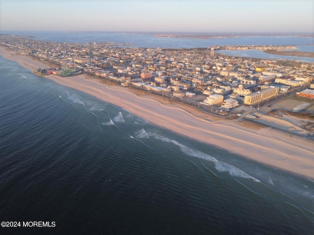 aerial view with a water view and a view of the beach