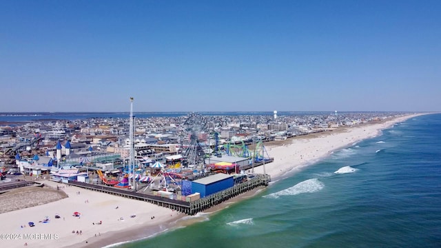 birds eye view of property featuring a beach view and a water view