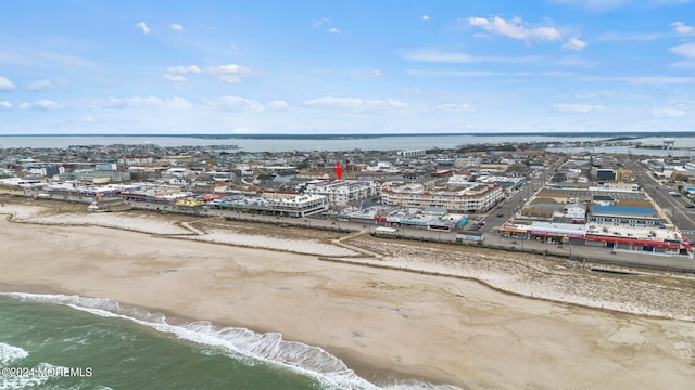 aerial view with a water view and a view of the beach