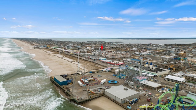 bird's eye view with a water view and a beach view