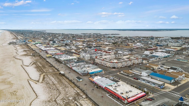 birds eye view of property featuring a beach view and a water view