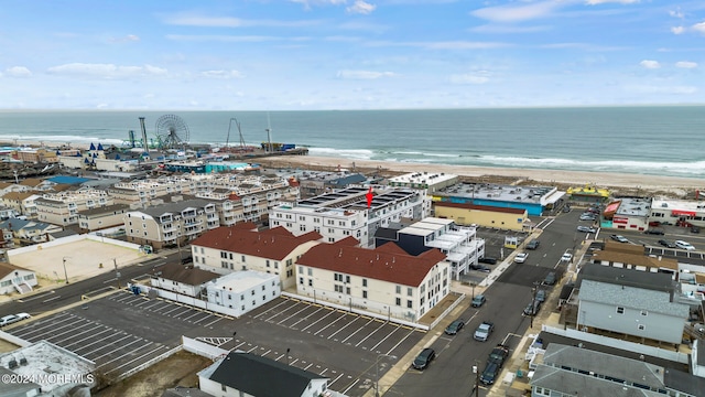 birds eye view of property with a view of the beach and a water view