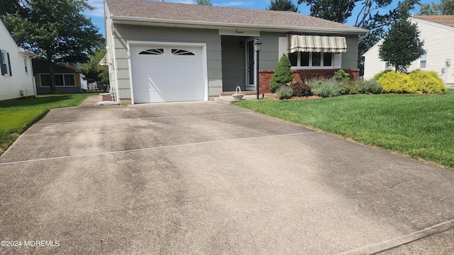 view of front of house with a garage and a front yard