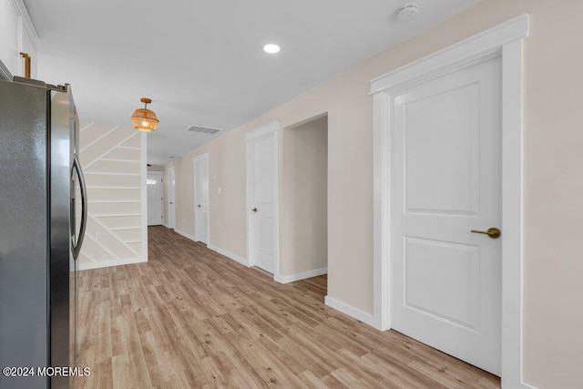 corridor with light hardwood / wood-style floors