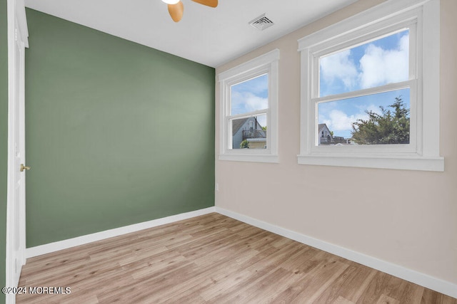 empty room with light wood-type flooring and ceiling fan