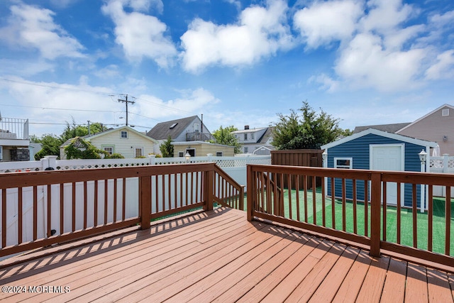 deck with a lawn and a shed