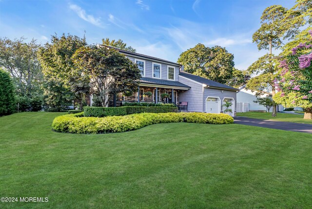 view of front facade with a garage and a front lawn