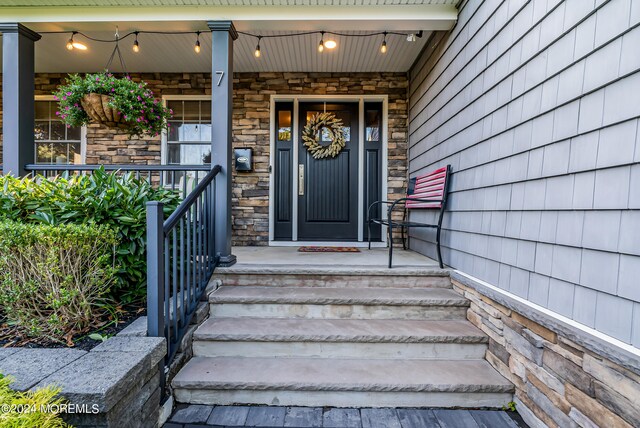 view of exterior entry featuring a porch