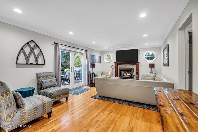 living room with crown molding, french doors, and hardwood / wood-style flooring