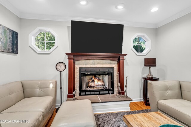 living room with ornamental molding and wood-type flooring