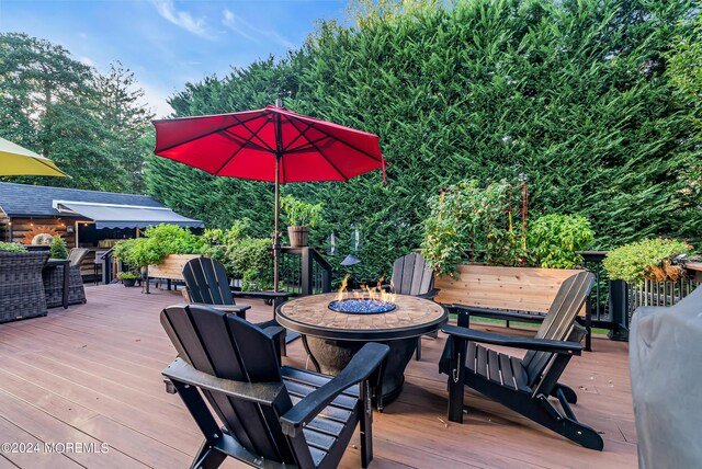 wooden terrace featuring a fire pit