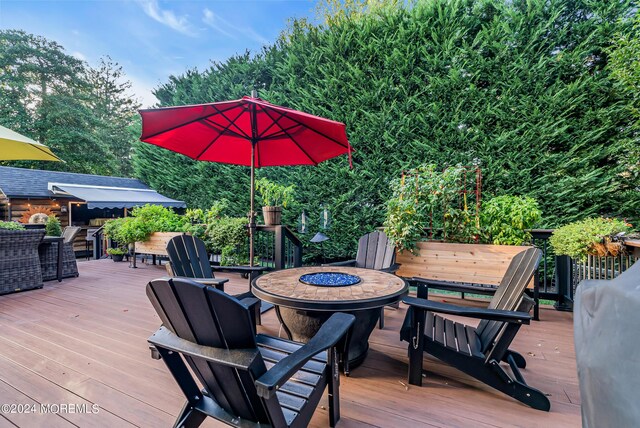 wooden terrace featuring a fire pit