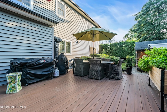 wooden deck with a grill