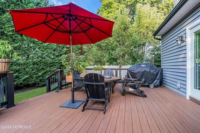 wooden deck featuring a grill