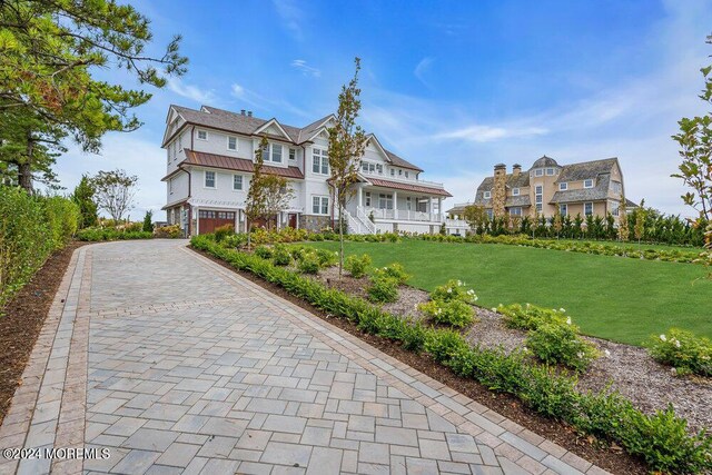 view of front of house with a front yard and a garage