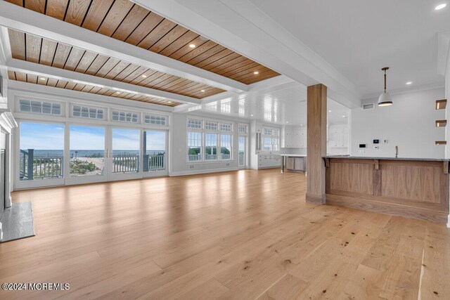 unfurnished living room with wood ceiling, light hardwood / wood-style floors, and beamed ceiling