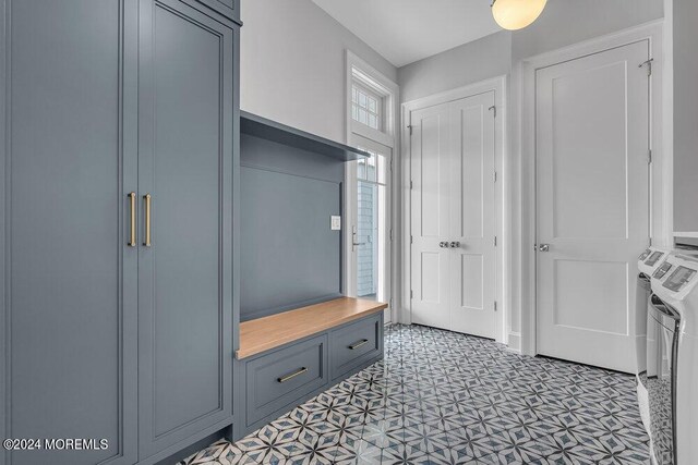 mudroom with independent washer and dryer