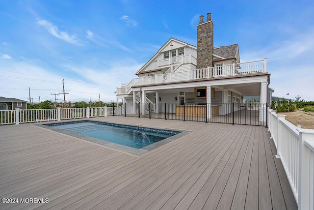 view of swimming pool with a deck and a patio area